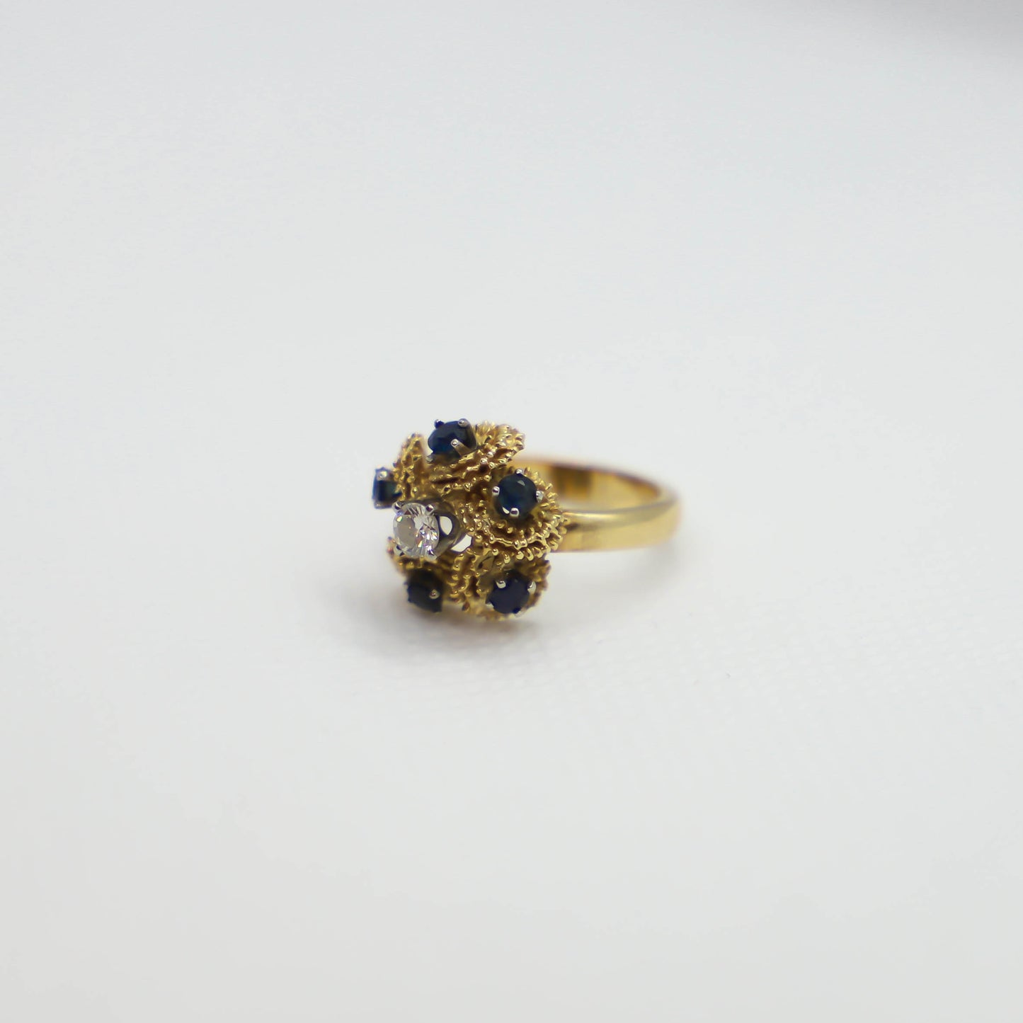 Yellow gold sapphire and diamond cluster ring